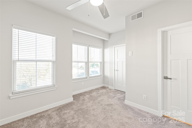 unfurnished room with light carpet and ceiling fan