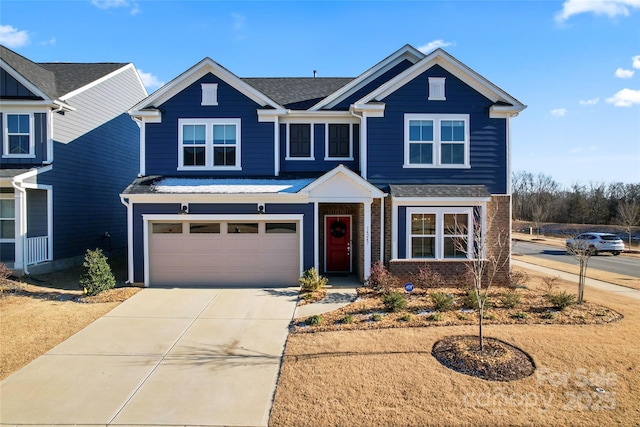 view of front of house with driveway, an attached garage, and brick siding