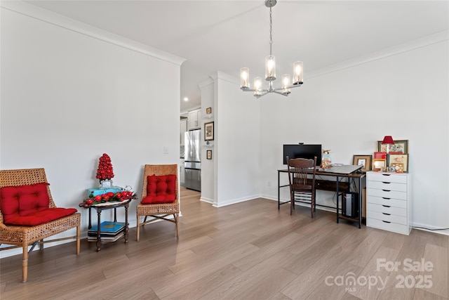 sitting room with baseboards, light wood finished floors, an inviting chandelier, and crown molding