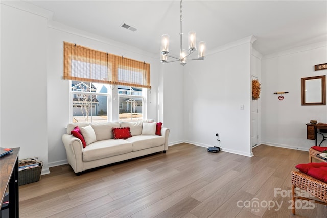 living area with a chandelier, visible vents, light wood-style flooring, and baseboards