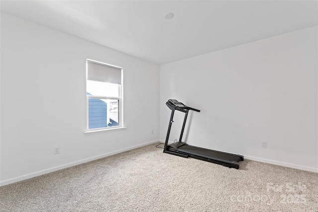 exercise room with carpet flooring and baseboards