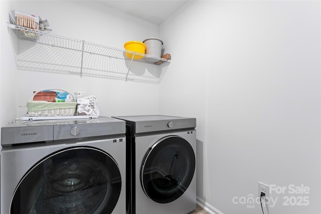 washroom featuring laundry area and washer and clothes dryer