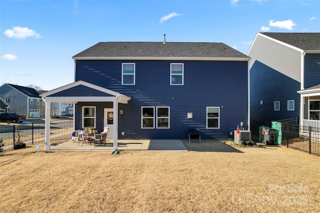 rear view of property with a patio, a yard, and fence