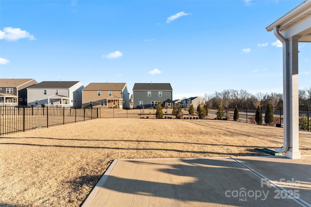 view of yard with a residential view and fence