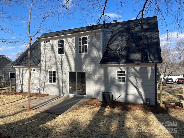 rear view of house featuring cooling unit and a patio