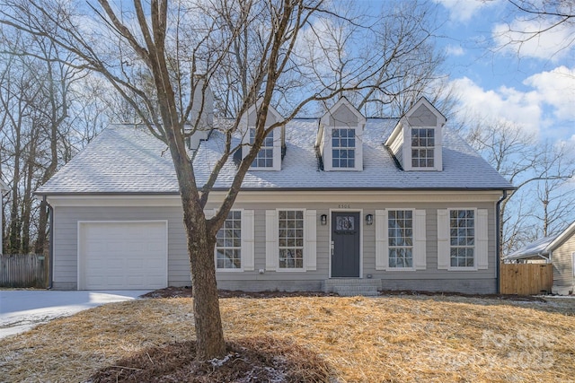 cape cod home with a garage