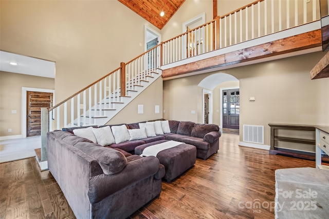 living room with dark wood-type flooring, high vaulted ceiling, and wooden ceiling