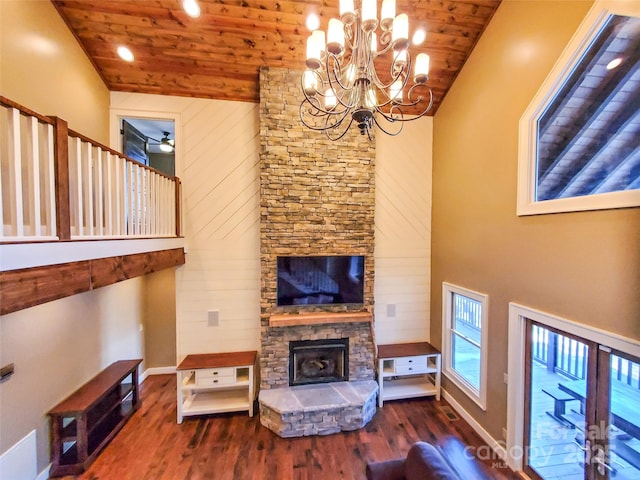 living room featuring a stone fireplace, dark hardwood / wood-style flooring, high vaulted ceiling, and wooden ceiling