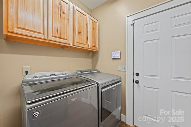 laundry room featuring cabinets and washing machine and clothes dryer