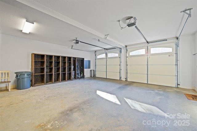 garage with a garage door opener and electric panel