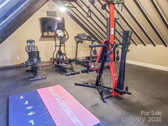 exercise room with vaulted ceiling