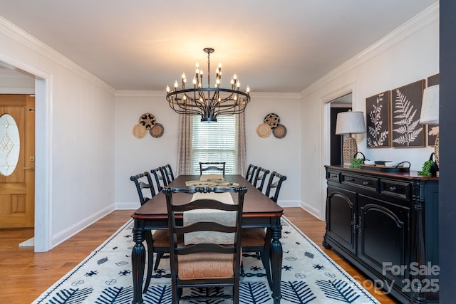 dining area with an inviting chandelier, ornamental molding, and wood-type flooring