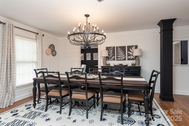 dining room with ornamental molding, wood-type flooring, and an inviting chandelier