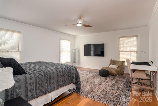 bedroom with multiple windows, hardwood / wood-style floors, crown molding, and ceiling fan