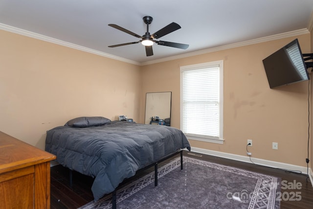 bedroom featuring dark hardwood / wood-style flooring, ornamental molding, and ceiling fan