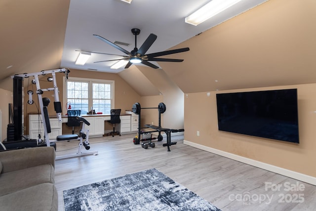 exercise room with lofted ceiling, radiator, ceiling fan, and light wood-type flooring