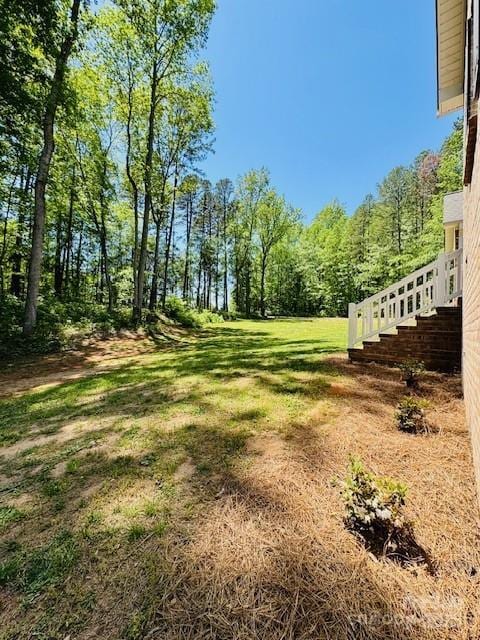 view of yard with a wooded view