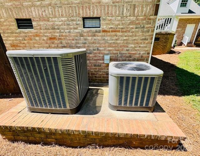 exterior details with central air condition unit and brick siding