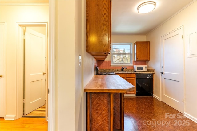 615 Biltmore Ave Unit T7, Asheville, NC 28803 - kitchen featuring black dishwasher, range, white microwave, brown cabinets, and crown molding