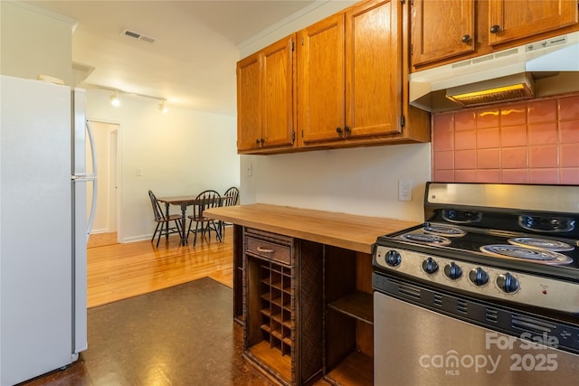 615 Biltmore Ave Unit T7, Asheville, NC 28803 - kitchen with visible vents, brown cabinetry, freestanding refrigerator, stainless steel electric stove, and under cabinet range hood