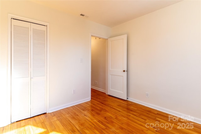 615 Biltmore Ave Unit T7, Asheville, NC 28803 - unfurnished bedroom featuring light wood-style floors, visible vents, baseboards, and a closet