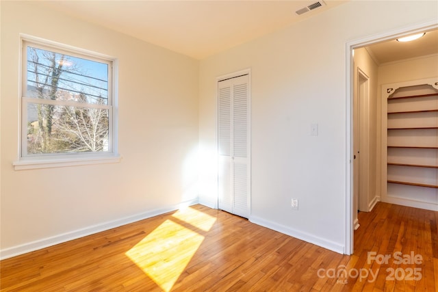 615 Biltmore Ave Unit T7, Asheville, NC 28803 - unfurnished bedroom featuring baseboards, a closet, visible vents, and wood finished floors