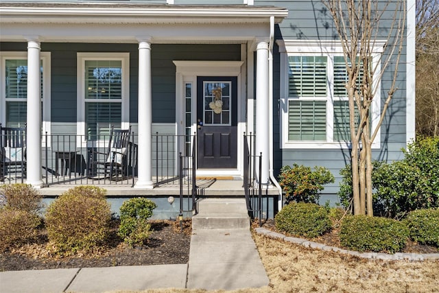 view of exterior entry with a porch