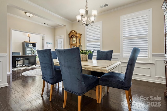 dining room with crown molding, an inviting chandelier, and dark hardwood / wood-style flooring