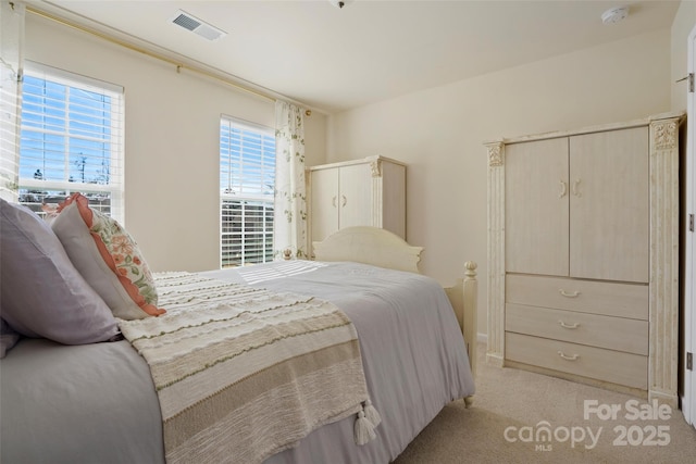 bedroom with light colored carpet