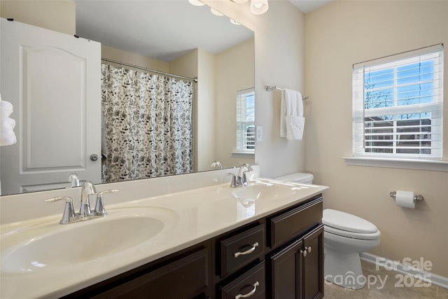 bathroom with vanity, tile patterned flooring, and toilet