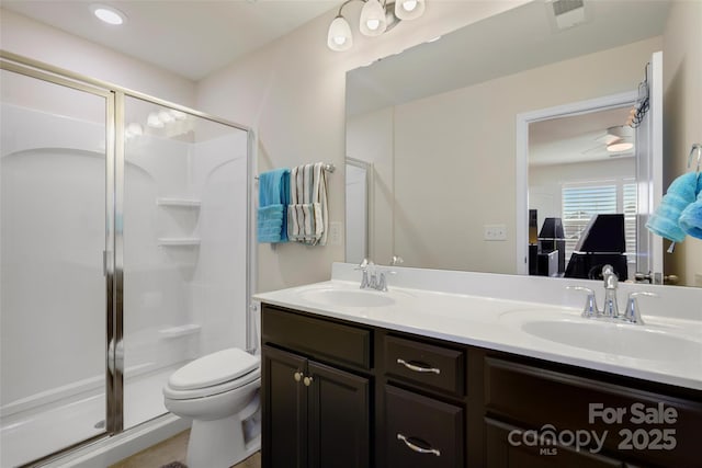 bathroom featuring vanity, toilet, and walk in shower