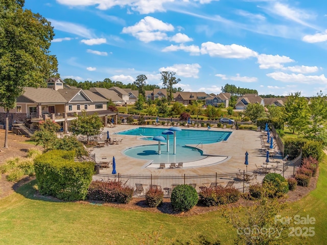 view of swimming pool with a patio area and a lawn