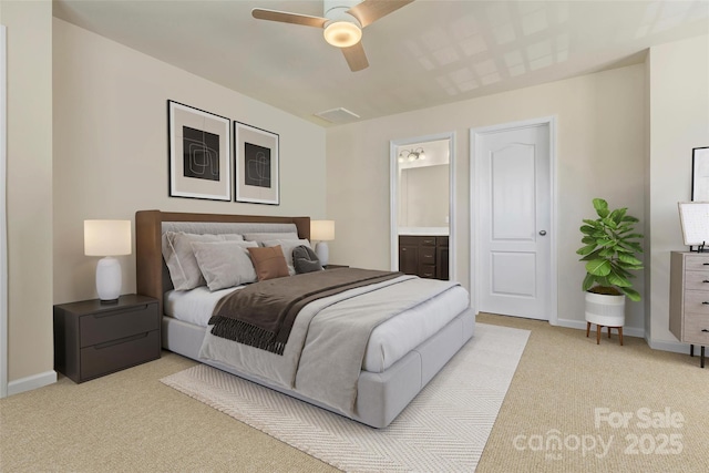 carpeted bedroom with ensuite bathroom and ceiling fan