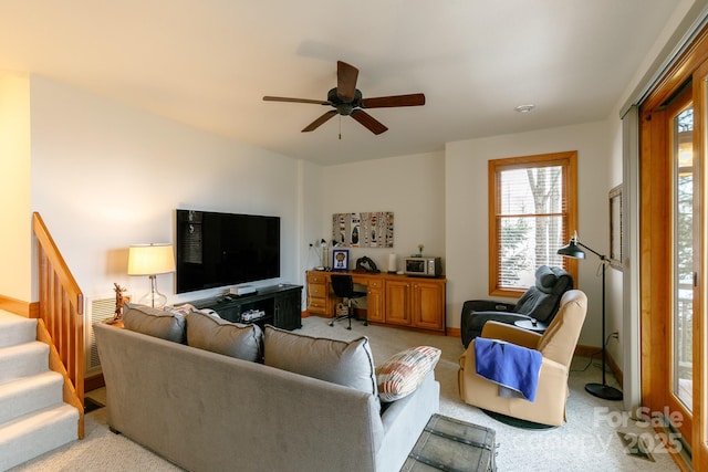 living room featuring light colored carpet and ceiling fan