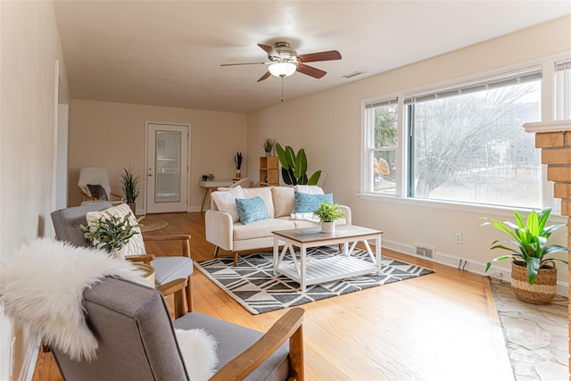 living room with ceiling fan and hardwood / wood-style floors