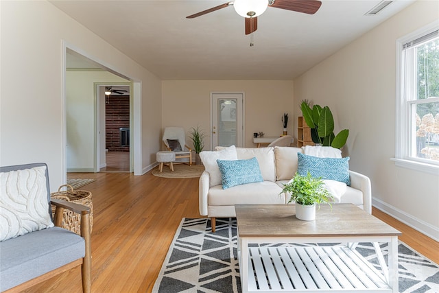 living room with ceiling fan and light wood-type flooring