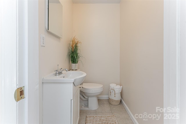 bathroom with tile patterned flooring, vanity, and toilet