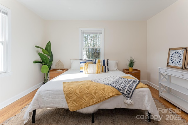 bedroom with wood-type flooring