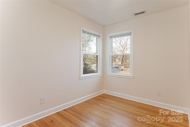 unfurnished room featuring light hardwood / wood-style floors