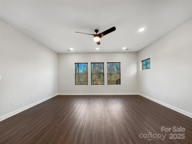 unfurnished room with ceiling fan and dark hardwood / wood-style flooring