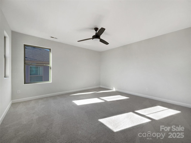 carpeted spare room featuring ceiling fan