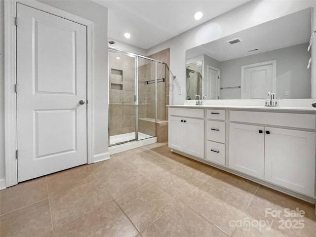 bathroom with vanity, tile patterned floors, and walk in shower