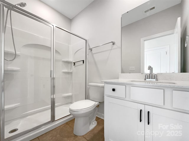 bathroom with tile patterned flooring, vanity, toilet, and walk in shower