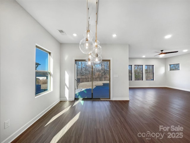 unfurnished dining area with dark wood-type flooring and ceiling fan