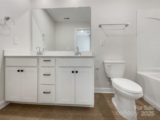 bathroom featuring vanity, toilet, tile patterned flooring, and a tub