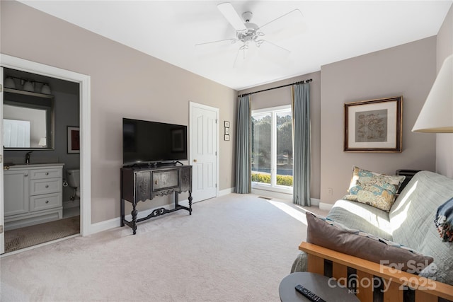 carpeted living room featuring ceiling fan and sink