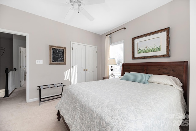 bedroom with light carpet, ceiling fan, and a closet