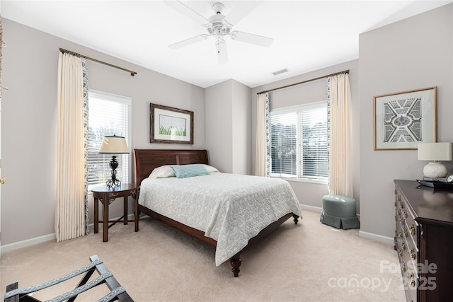 carpeted bedroom with multiple windows and ceiling fan