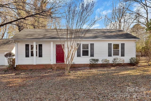 ranch-style home featuring a garage and entry steps