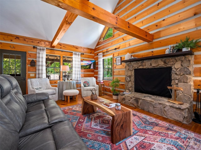 living room with hardwood / wood-style floors, log walls, a stone fireplace, and vaulted ceiling with beams